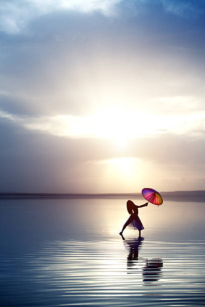 istock Aesthetic dancing on the beach with umbrella 476864090