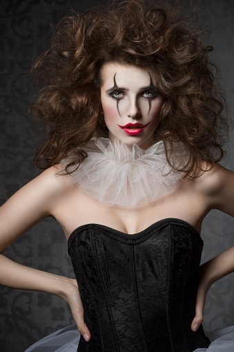 vintage dancer woman with gothic tutu, clown make-up and crazy hair-style. Creative fashion masquerade