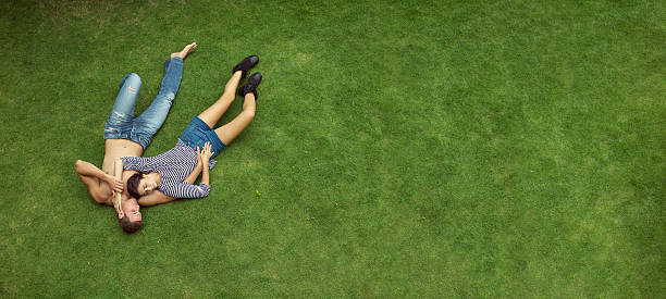 istock beautiful love couple lying in a meadow 476864876