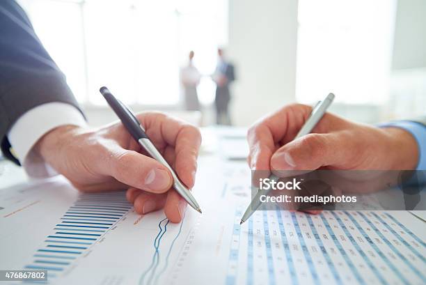 Analyzing Statistics Stock Photo - Download Image Now - 2015, Adult, Adults Only