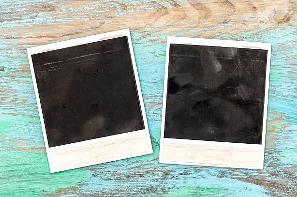 istock Vintage style photo frames on rustic wooden background 476870734