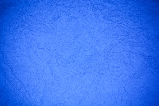 istock Crumpled vintage blue paper textured obsolete background. 476871796