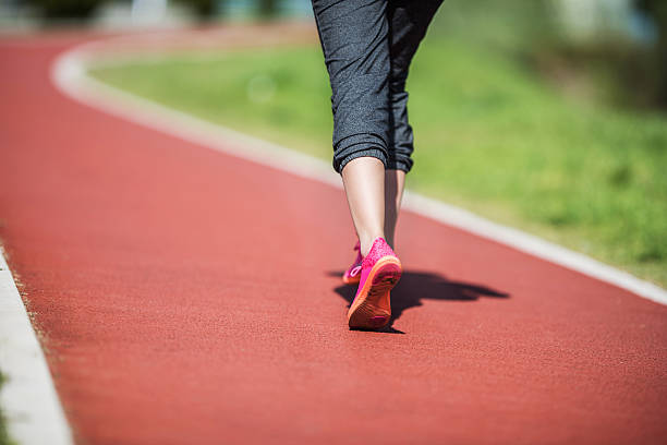 istock Unrecognizable person running on a running track outdoors. 476873896