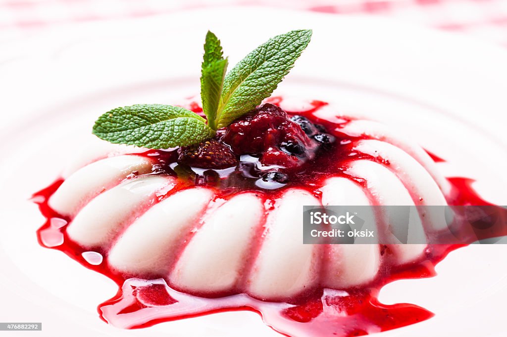 Panna cotta, S. Panna cotta with berry sauce and mint leaf close up Blueberry Stock Photo