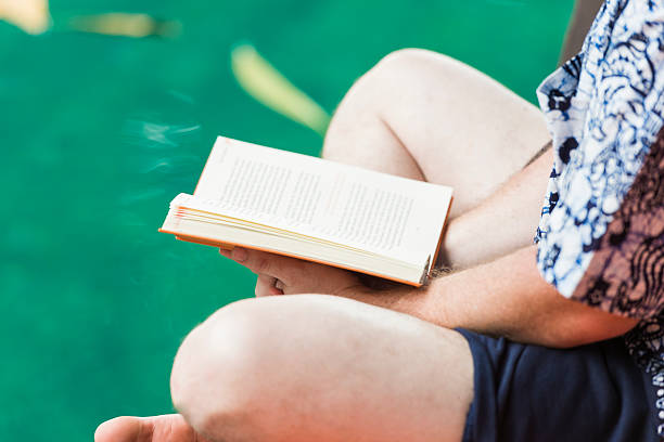 istock Man Reading Book Next to Pool on Vacation in Bali 476886164