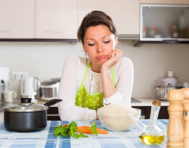 istock Sad woman cooking rice in the kitchen 476889906