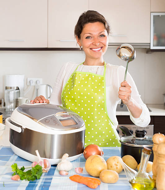 istock Woman cooking with multicooker 476890016