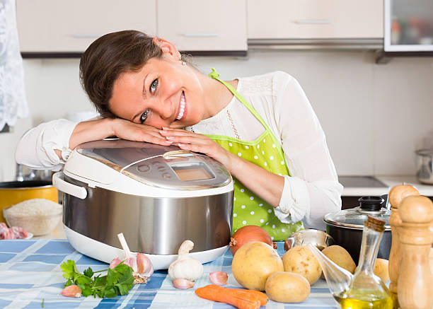istock Housewife cooking with multicooker 476890042