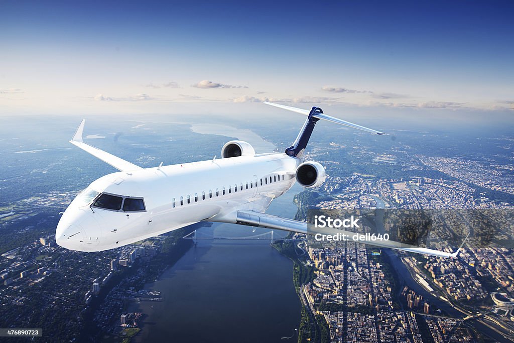 Private jet plane in the blue sky Aerospace Industry Stock Photo