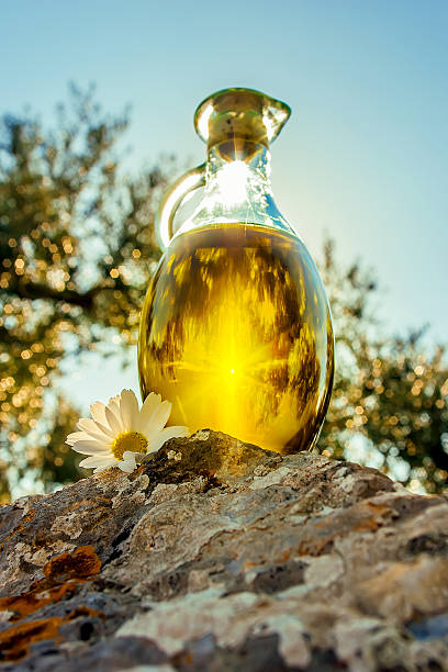 Sun light through the bottle with olive oil stock photo