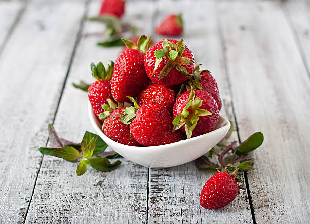 istock Fresh strawberries on an old wooden background 476896302