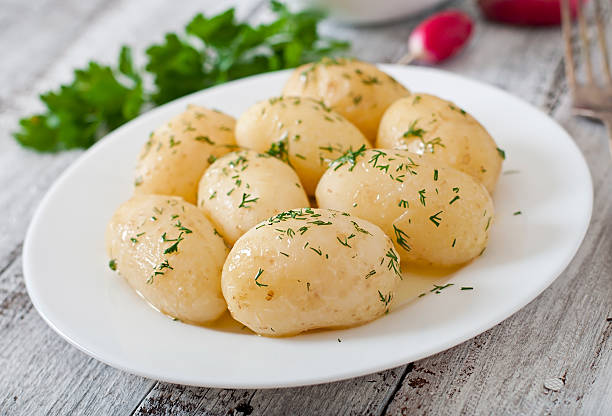 istock Young boiled potatoes with butter and dill 476896828