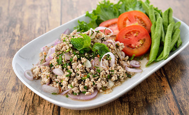istock spicy minced pork on plate with wood table background 476899458