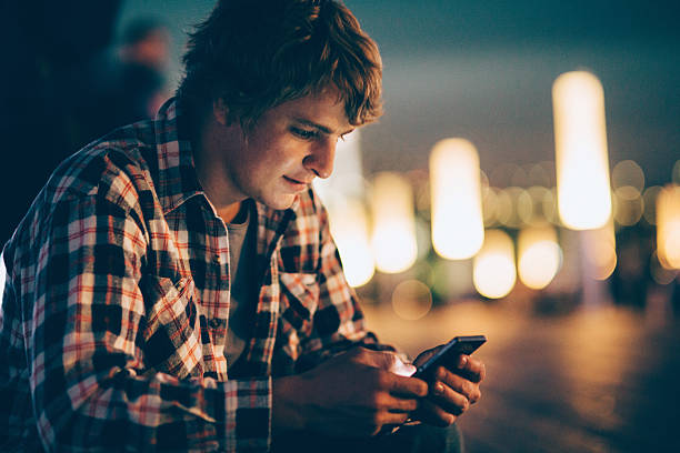 istock Young man texting on the phone 476899706