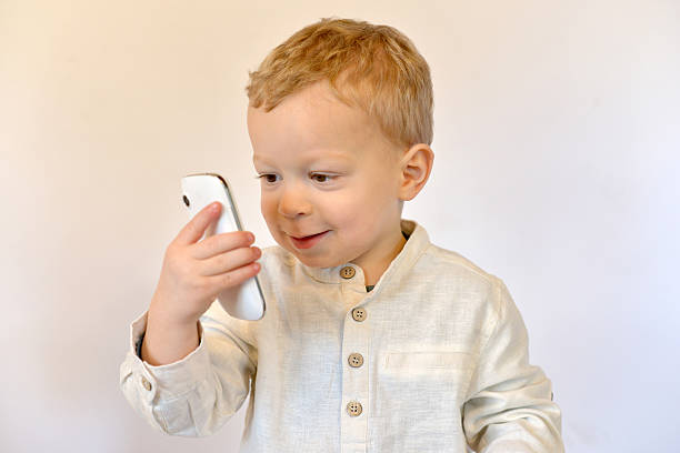 istock baby with a mobile phone 476901723