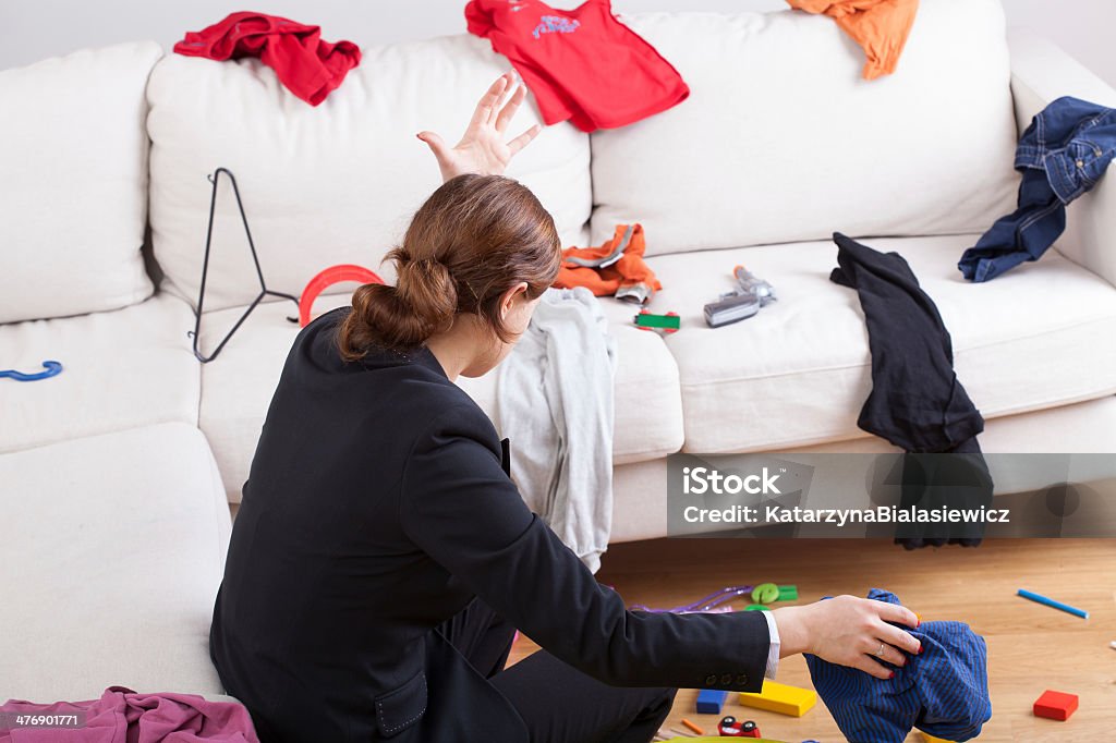 Woman in room of messy clothes An angry woman in a room full of clothes all over the place Chaos Stock Photo