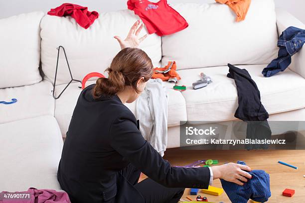 Woman In Room Of Messy Clothes Stock Photo - Download Image Now - Chaos, Messy, Housework