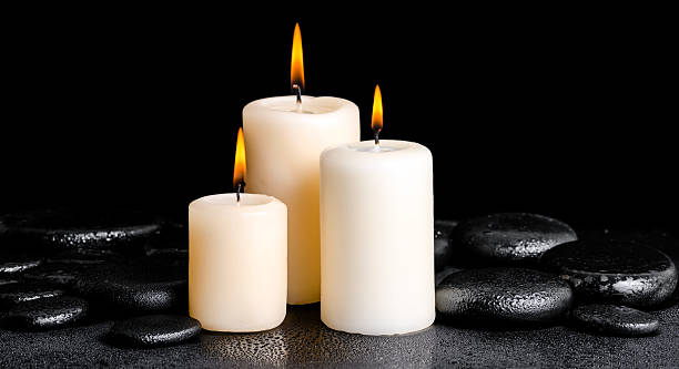 istock spa concept of white candles on zen basalt stones 476901940