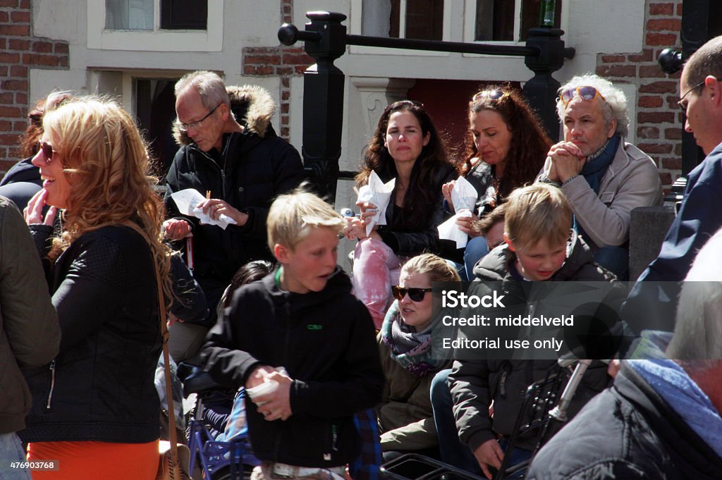 People having a break Haarlem, the Netherlands - April 27, 2015: People celebrate Koningsdag and having a brake in the city of Haarlem. As you can see the weather is fine and they enjoy it very much.  2015 Stock Photo