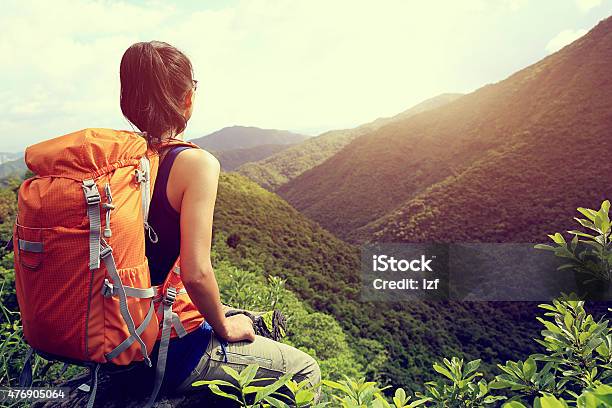 Woman Backpacker Enjoy The View At Mountain Peak Cliff Stock Photo - Download Image Now