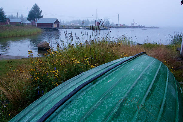 Boat laying overturned next to beach