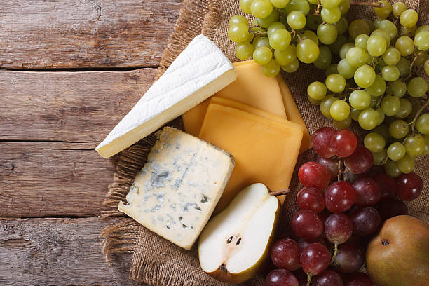 istock grapes, pears and cheese on the table. horizontal top view 476909694