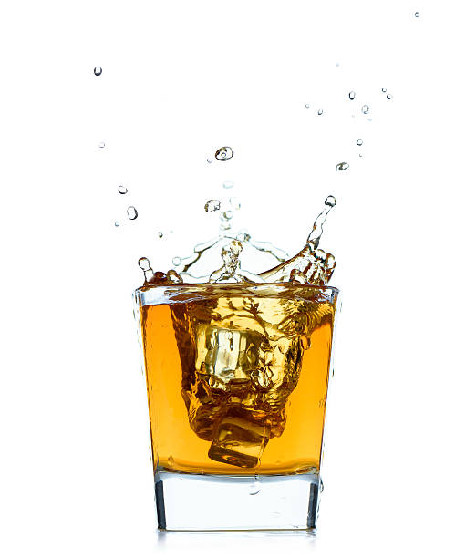 istock Glass with splashing whisky drink on white background. 476910186