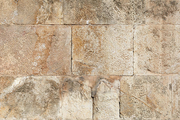 istock Ancient roman brown stone wall texture background 476916943