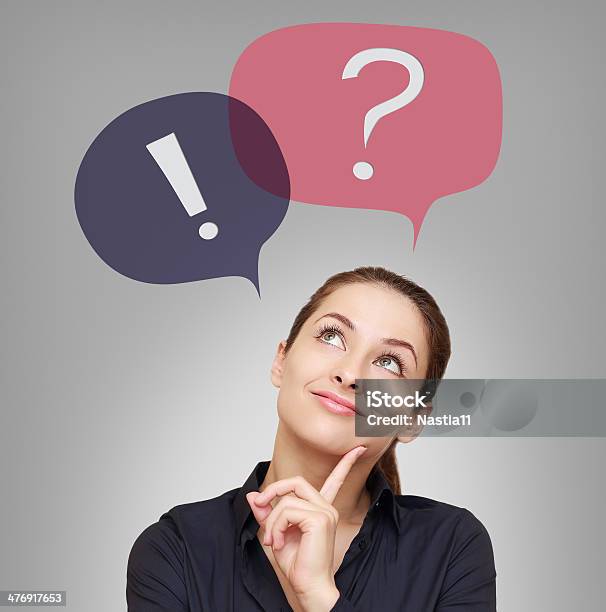 Thinking Woman Looking On Question And Exclamation Above Stock Photo - Download Image Now