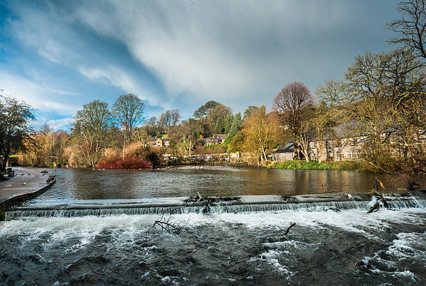 Bakewell Waterfall Rough, fast flowing high water on the river Wye, Bakewell. bakewell stock pictures, royalty-free photos & images
