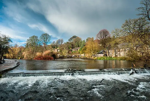 Rough, fast flowing high water on the river Wye, Bakewell.