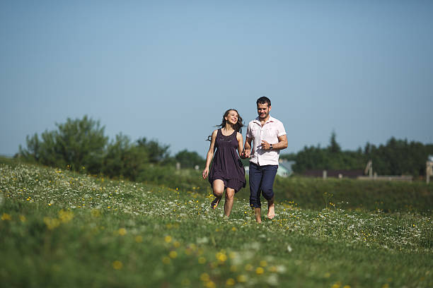 istock Couple running in field and have fun 476917946