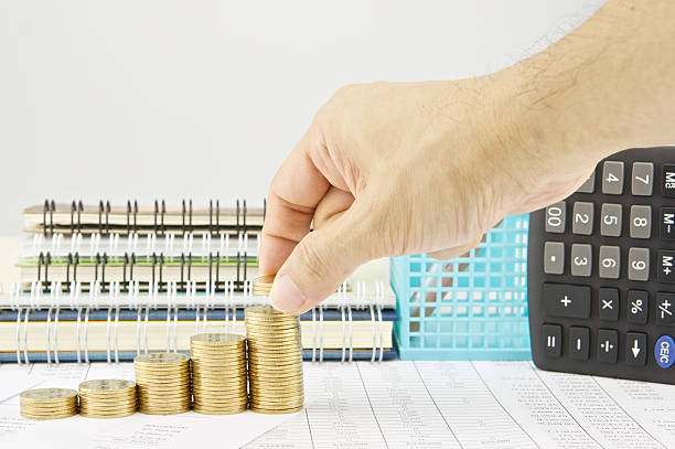 istock Man put coins on step pile of gold coins 476918168