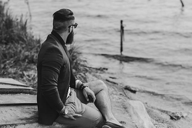 istock American Bearded Man looks on the river bank 476922044