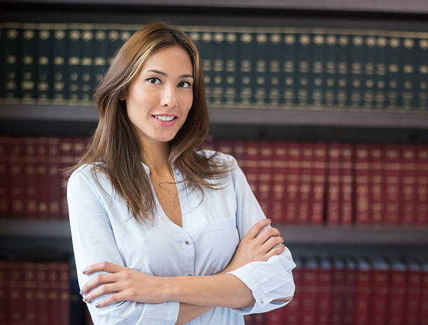Successful lawyer or business woman Successful Asian lawyer or business woman at the office with book at the background female lawyer stock pictures, royalty-free photos & images