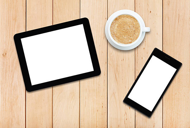 istock Two gadgets and coffee on a wooden table 476924686