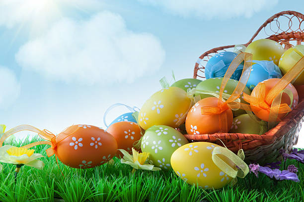 istock Color easter eggs in the grass against blue sky 476925133
