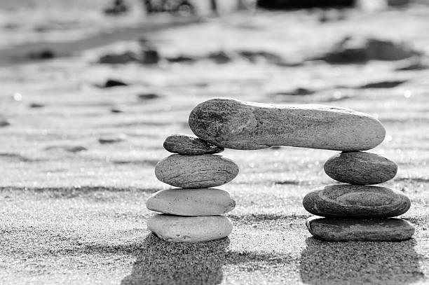 Zen Balancing Pebbles on Black Textured Background