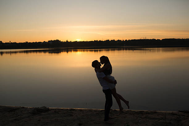 istock Couple in sunrise on the beach 476925652