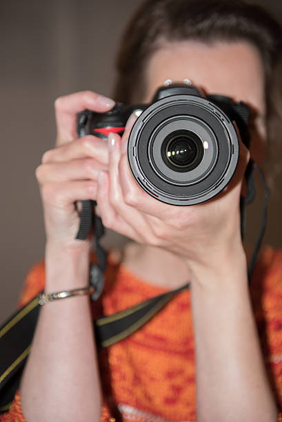 istock female Photographer at work with camera 476926032