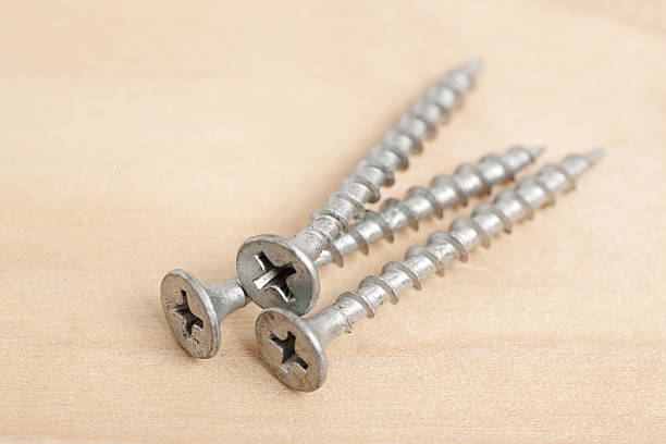 istock Screws on Wooden Background 476928606