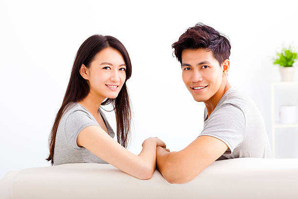 istock Young happy couple sitting on the sofa 476928822