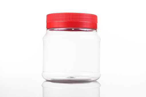 Translucent plastic PVC jar with red cover isolated in white