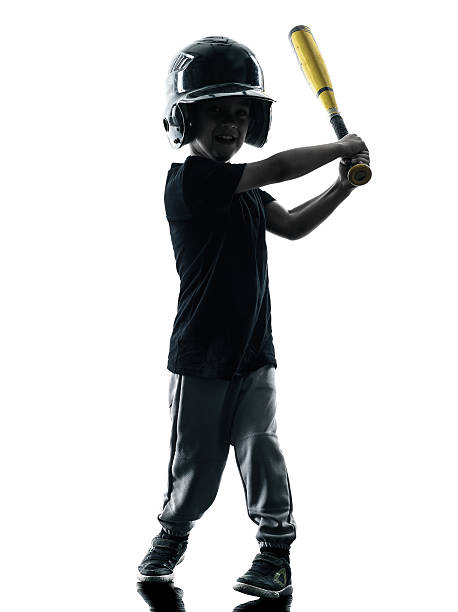 istock child playing softball players silhouette isolated 476936074