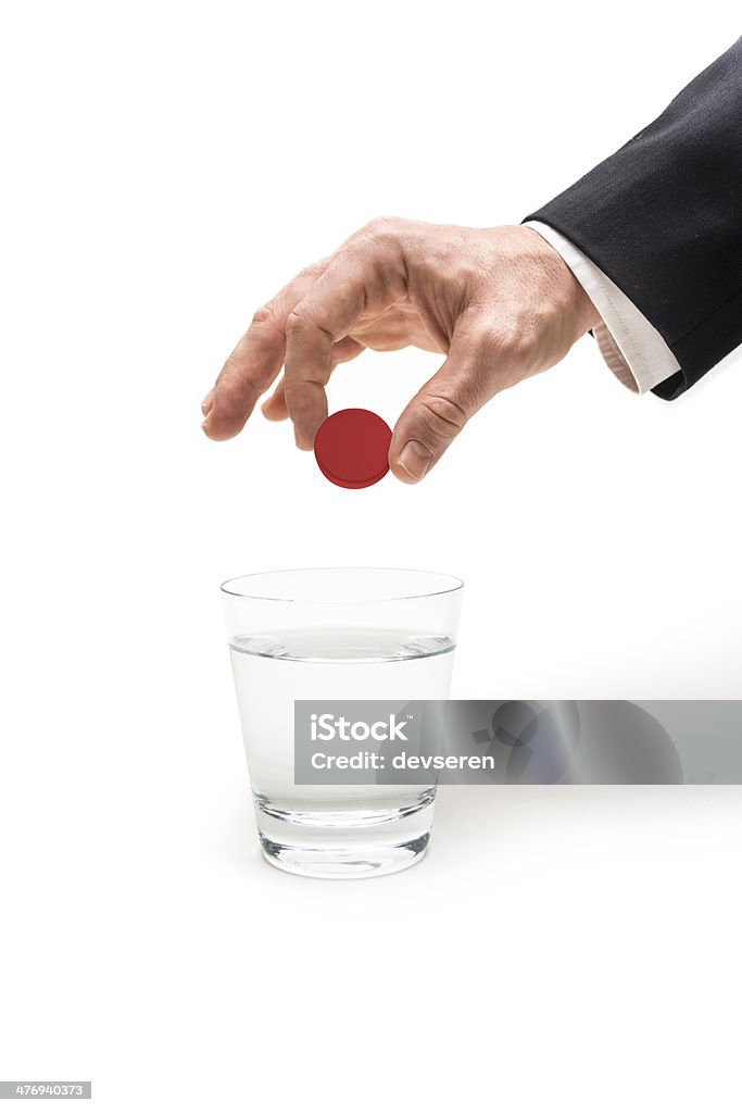 Magic Touch Businessman dropping a red pill to a glass of water. Acetaminophen Stock Photo
