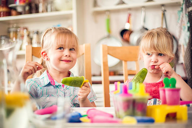 istock Two Little Girls Eating Popsicles 476944094