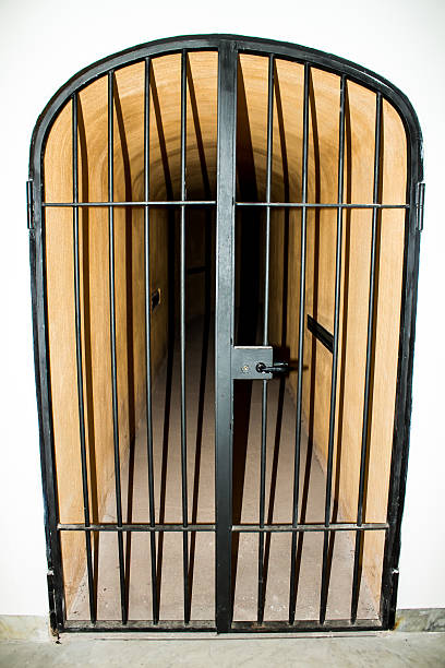 istock metal door with bars in a prison 476945180