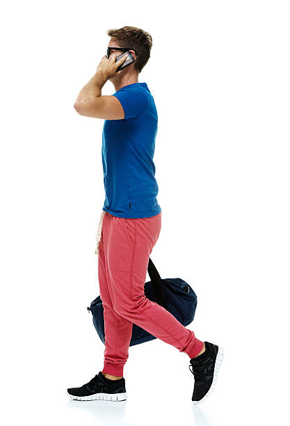 istock Casual man on mobile and walking 476945738