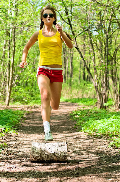 istock young woman running in park 476946919