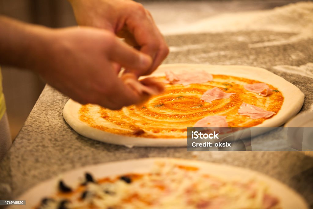 Making Pizza Making Pizza in restaurant, close up hands of chef 2015 Stock Photo